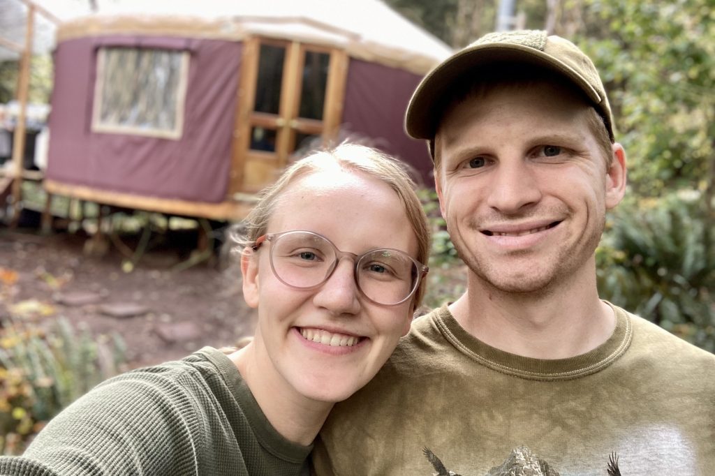 Jo and Cody in front of their yurt